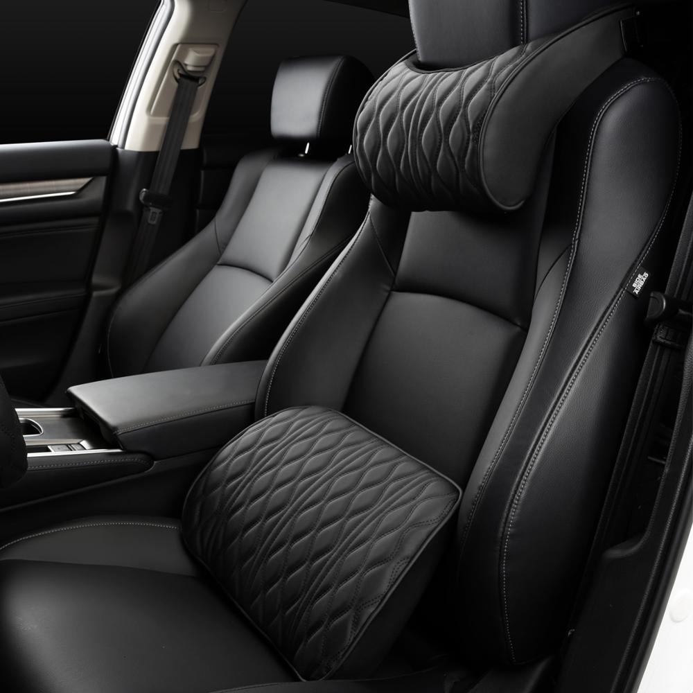 Black headrest pillow and lumbar support on a car seat